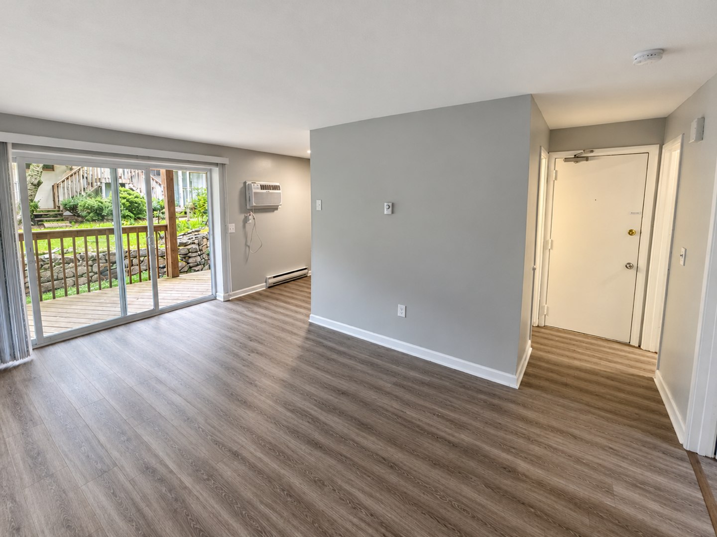 Bright living area with sliding doors leading to a private courtyard-facing deck